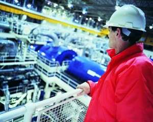 Power Generation man overlooking plant squared pic